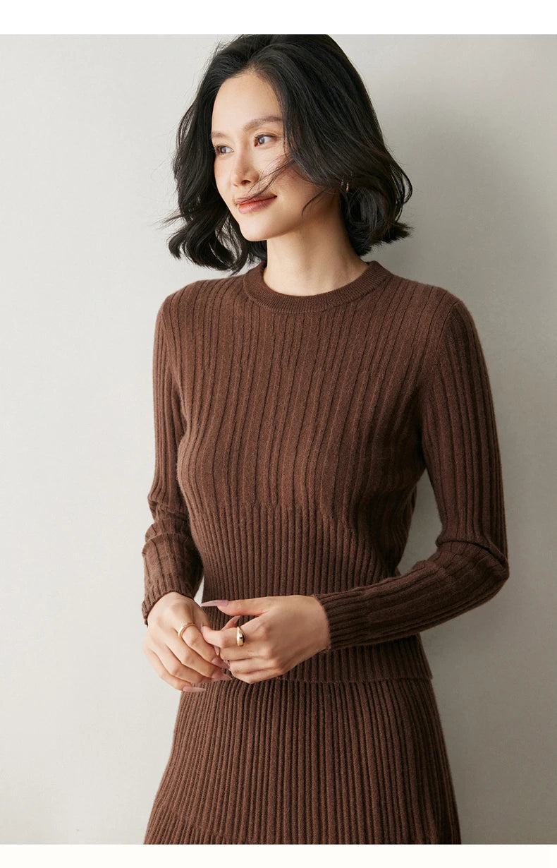Model in Café Noir abstract-striped sweater softly touching fingertips — From Borcelleclothes.