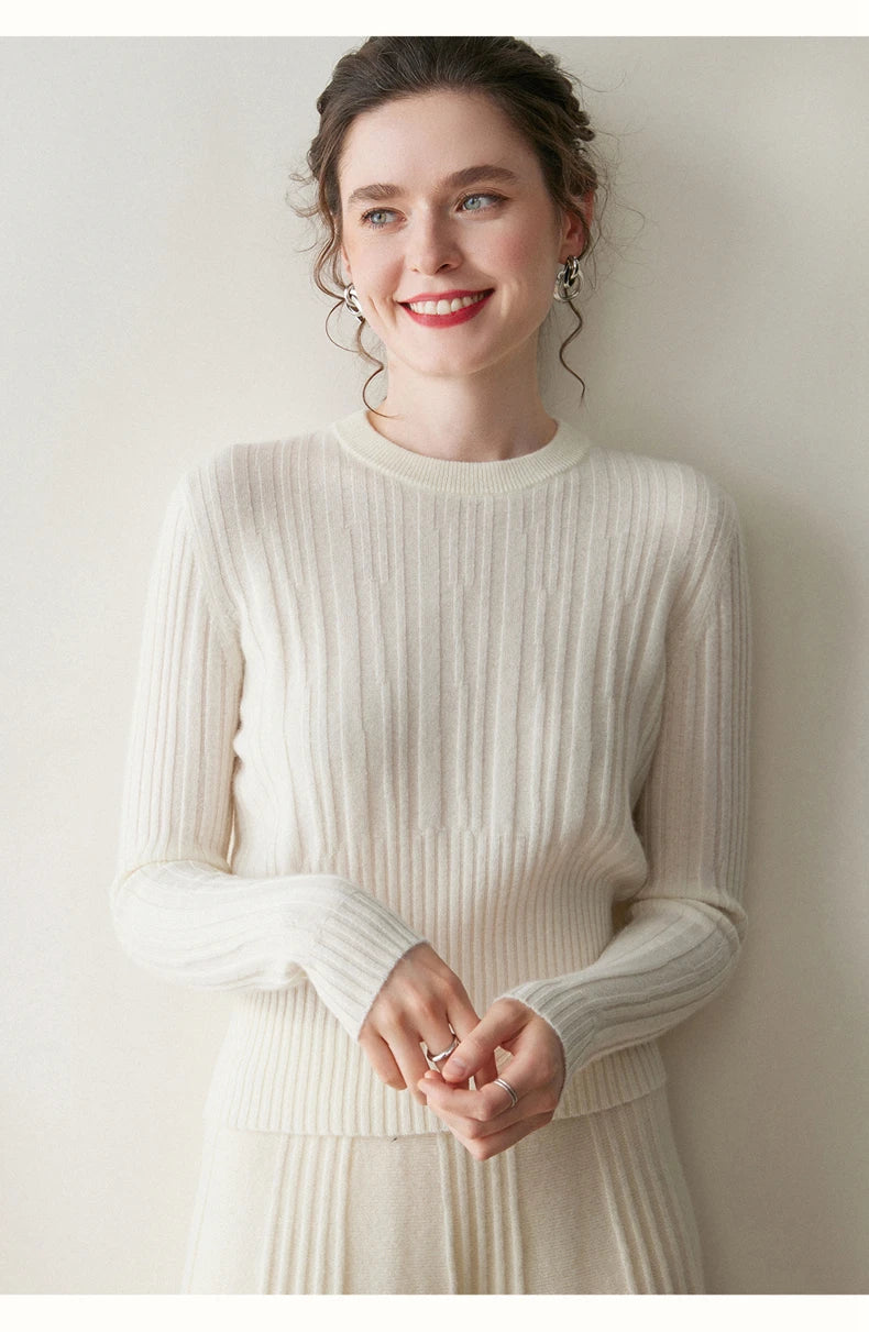 Model in Pearl Bush abstract-striped sweater with hands softly touching — From Borcelleclothes.