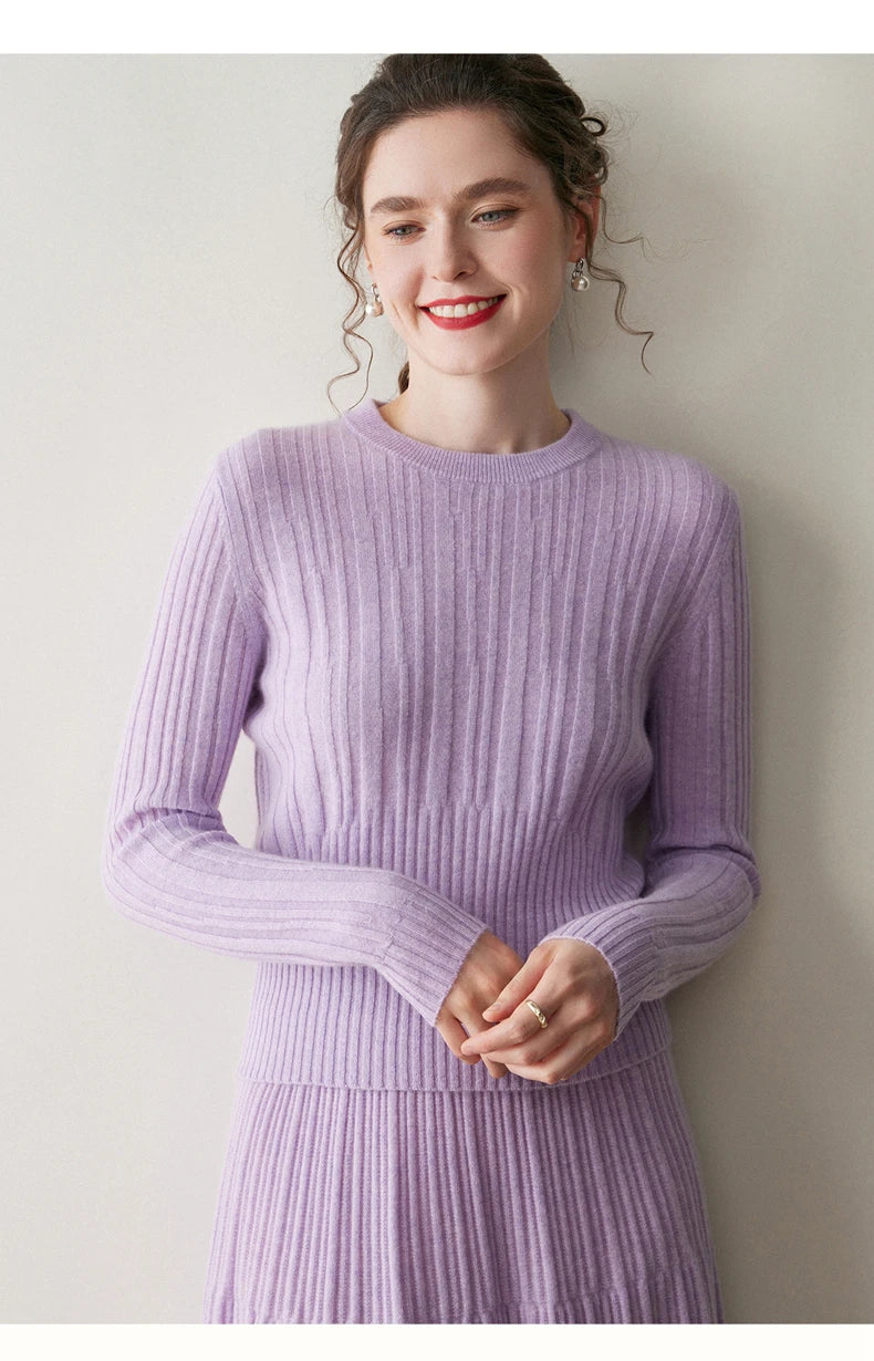 Model in Wisteria Purple abstract-striped cashmere sweater gently touching fingertips — From Borcelleclothes.