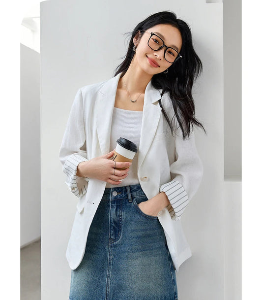 Woman in Alabaster Urban Blazer with her hand in a skirt pocket. From Borcelleclothes.