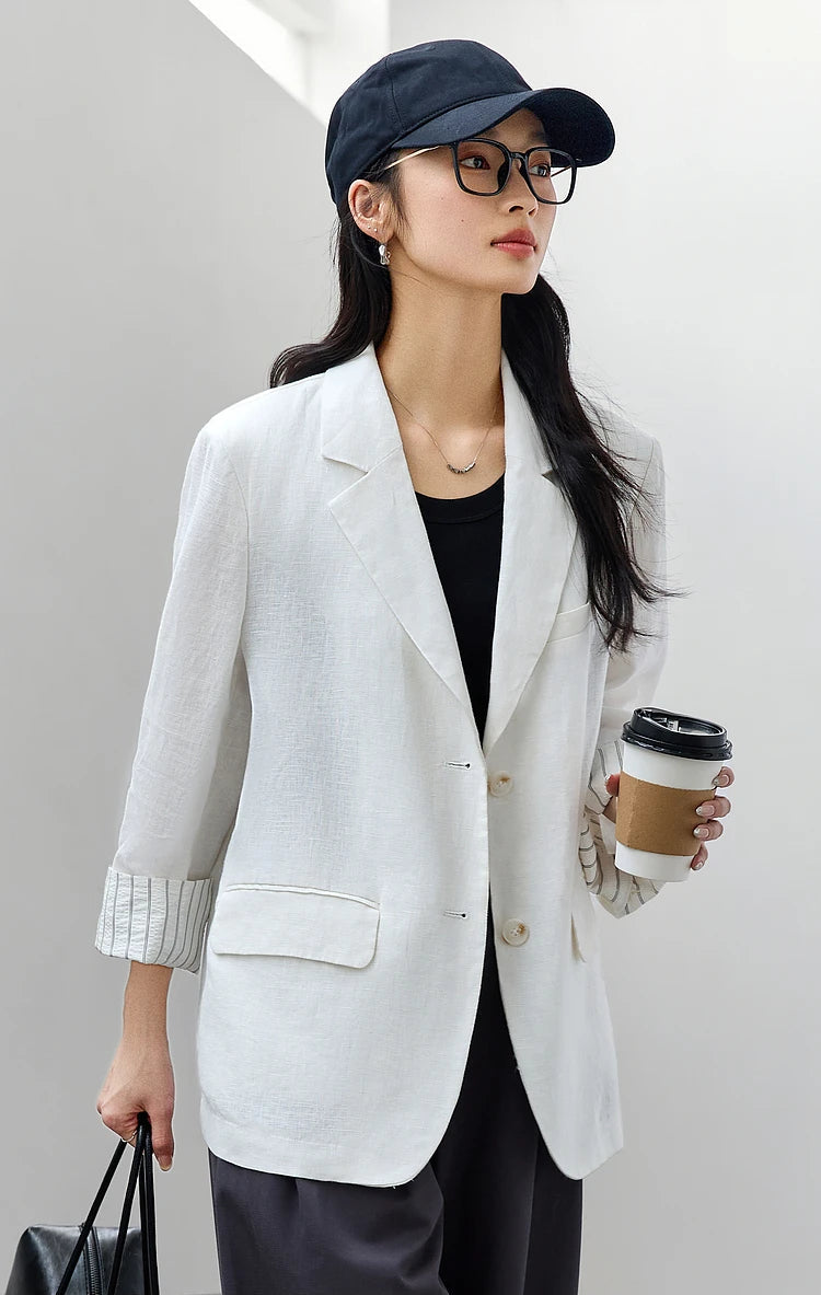 Woman in Alabaster Urban Blazer holding a cup of coffee. From Borcelleclothes.