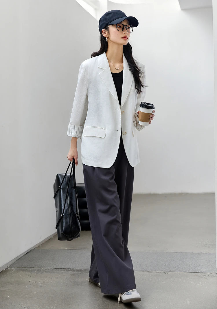 Side view of a woman walking in the Alabaster Urban Blazer. From Borcelleclothes.