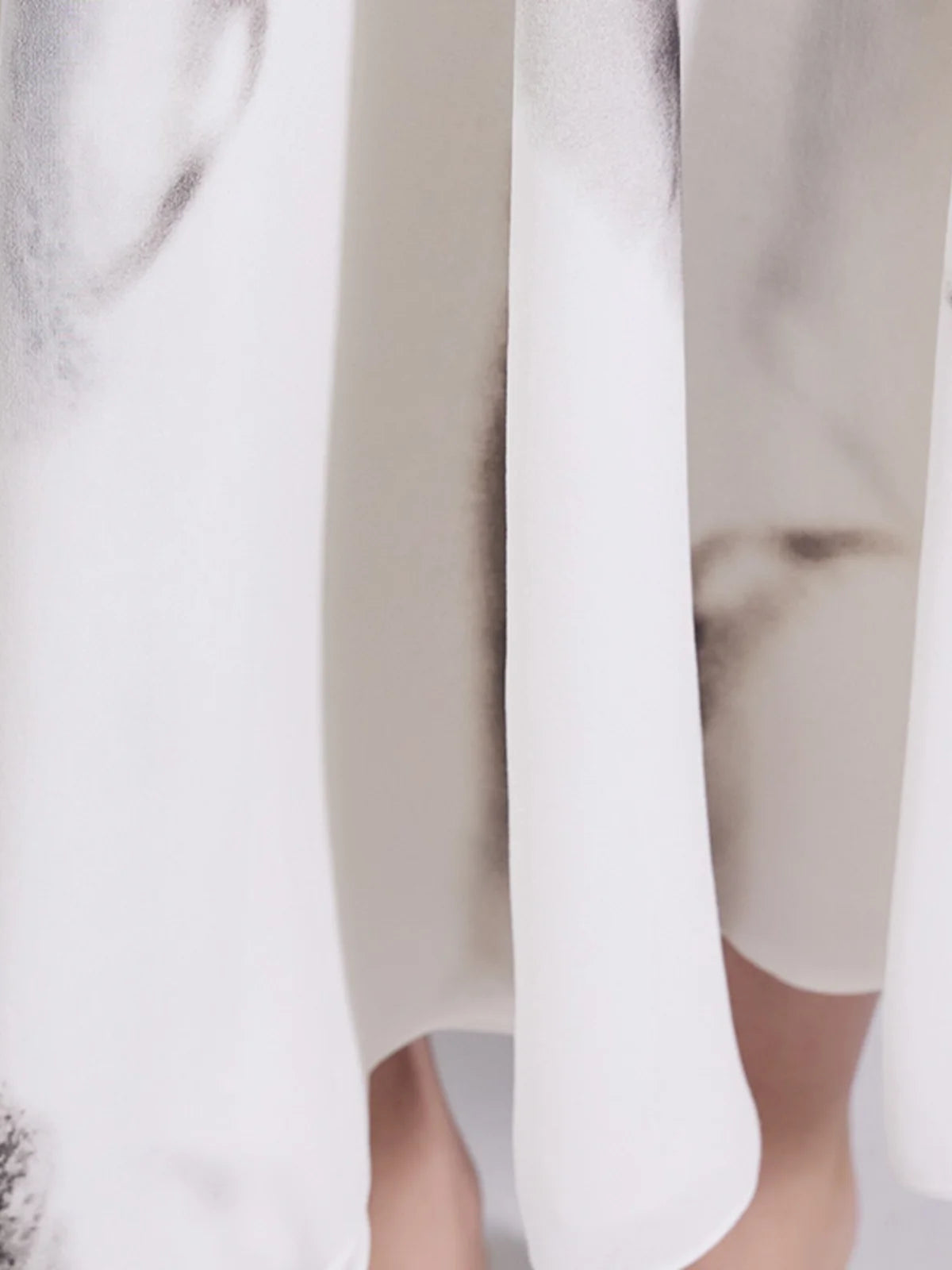 Detailed view of the lower panel draping in platinum silk georgette fabric. From Borcelleclothes.