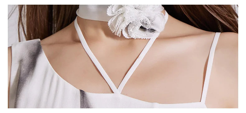 Close-up of the front shoulder area with neck flower and asymmetrical neckline. From Borcelleclothes.
