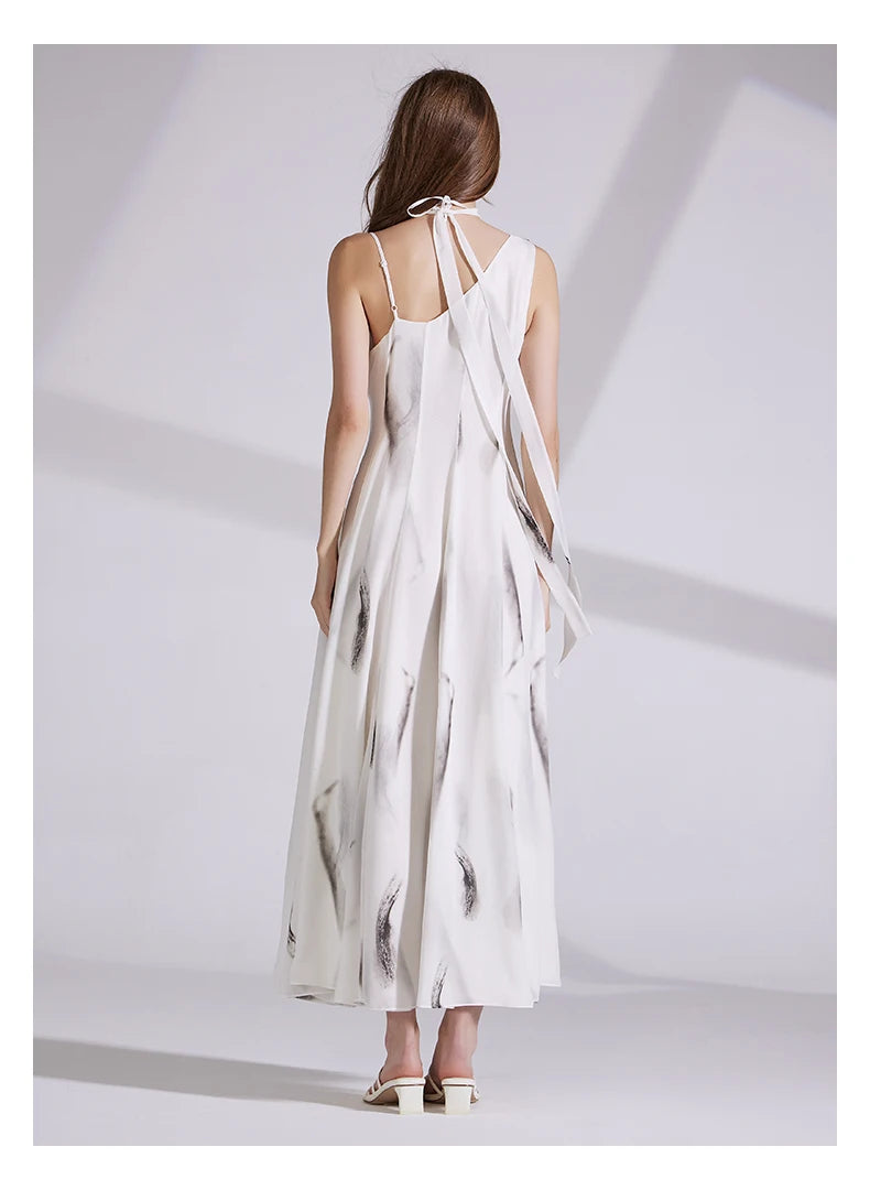 Back view of the platinum dress, showcasing the one-shoulder cut and flowing silhouette. From Borcelleclothes.