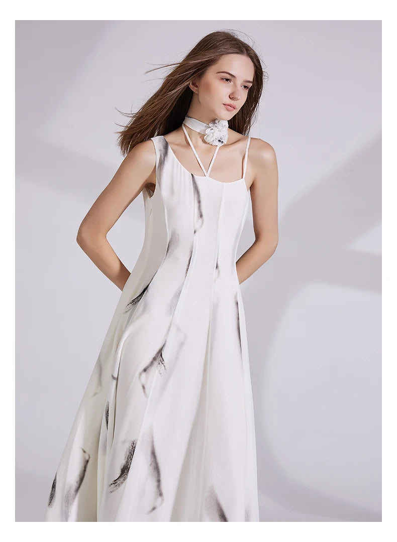 Model wearing platinum silk georgette dress with hands behind back, highlighting the asymmetrical neckline and subtle panel flare. From Borcelleclothes.