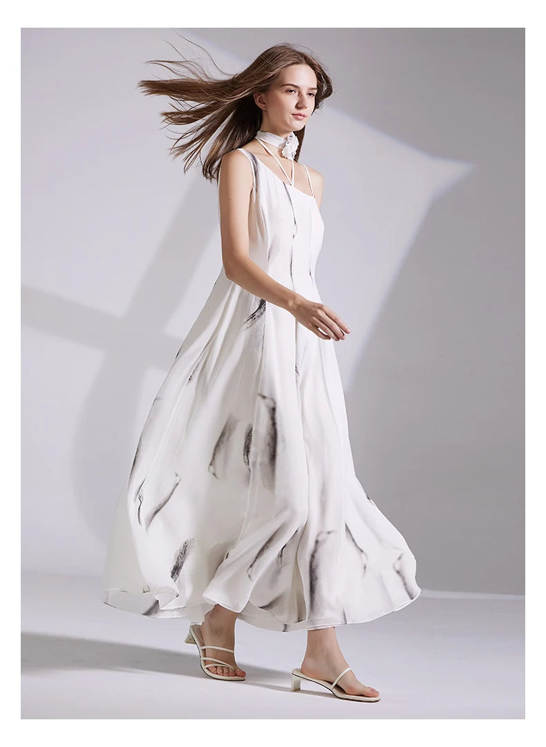 Model walking left in asymmetrical platinum dress, the fabric flowing with movement. From Borcelleclothes.