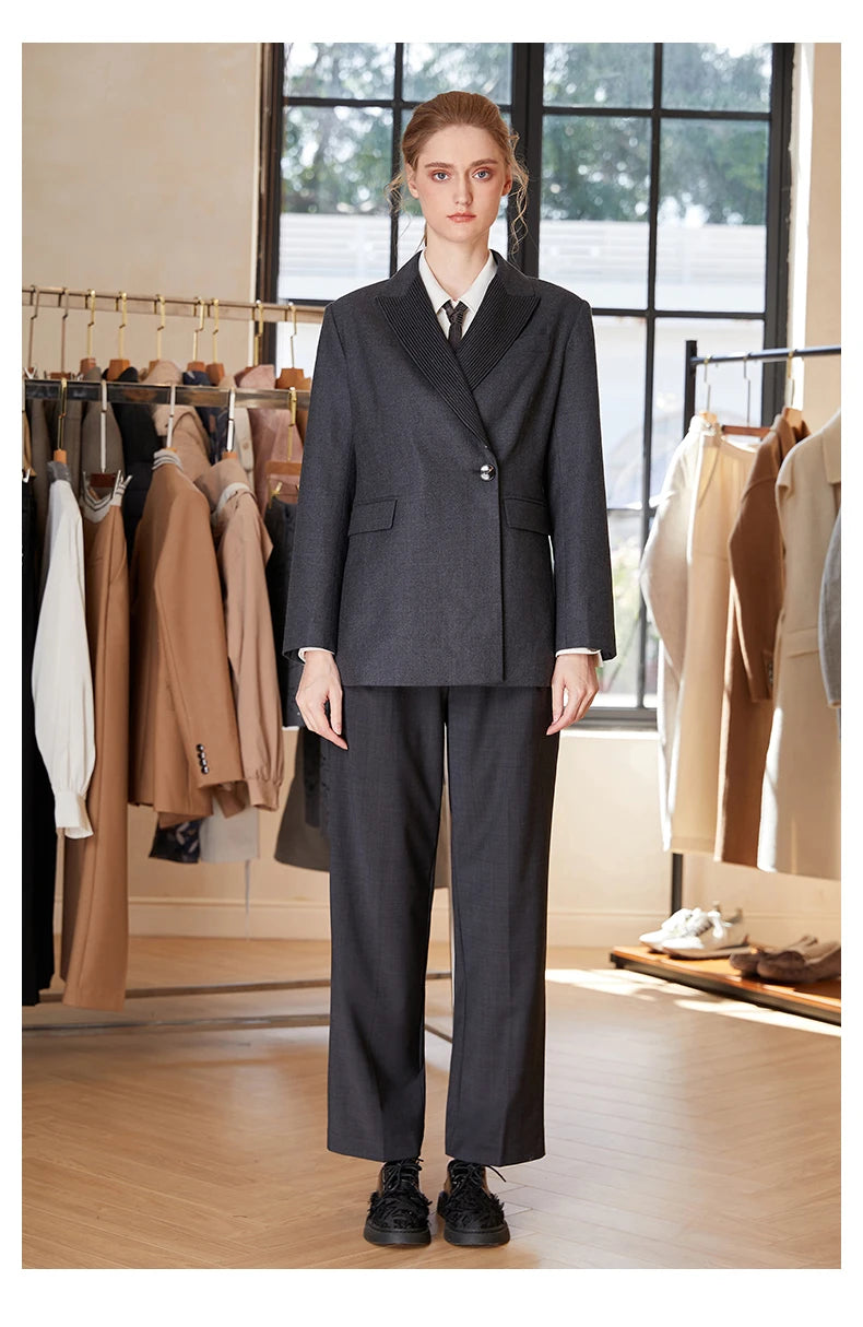 Women’s Australian wool blazer in Davy Grey with chain detail, model with arms straight. From Borcelleclothes.