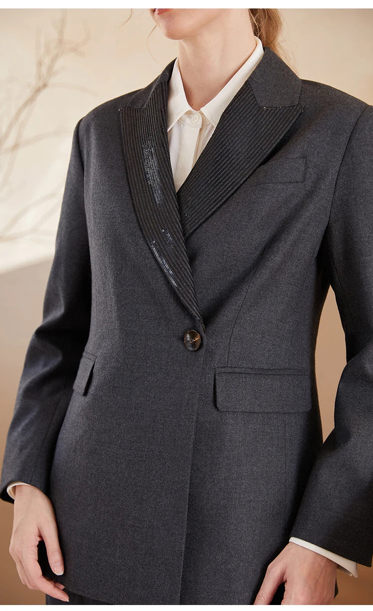 Women’s Australian wool blazer in Davy Grey with chain detail, model standing with hands on hips. From Borcelleclothes.