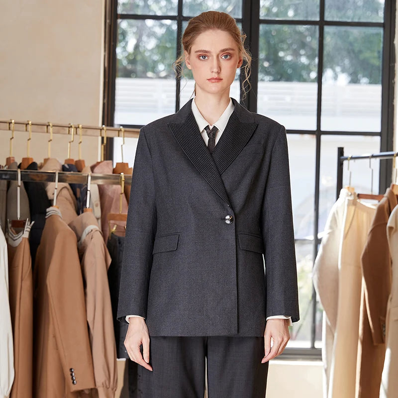 Women’s Australian wool blazer in Davy Grey, with chain detail, peaked lapels, single horn button, and high-set flap pockets — formal codes reimagined with feminine balance. From Borcelleclothes.