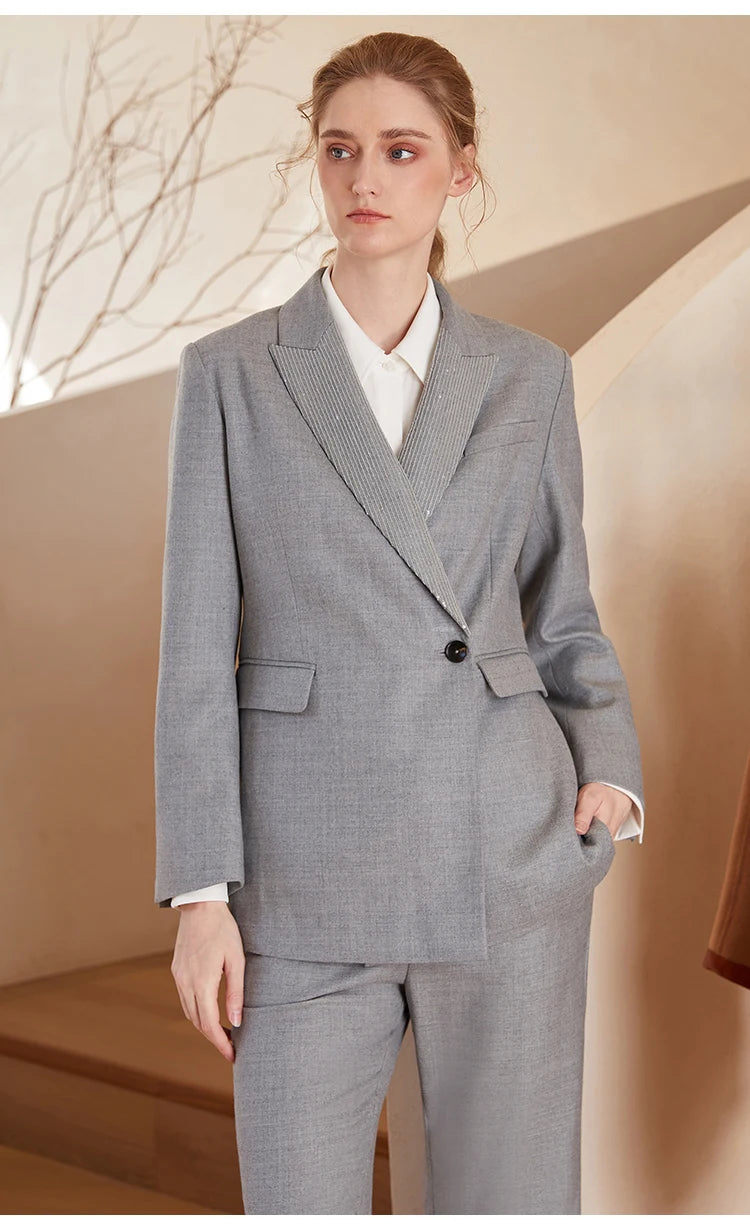Women’s Australian wool blazer in Mountain Mist with chain detail, model looking to the side. From Borcelleclothes.