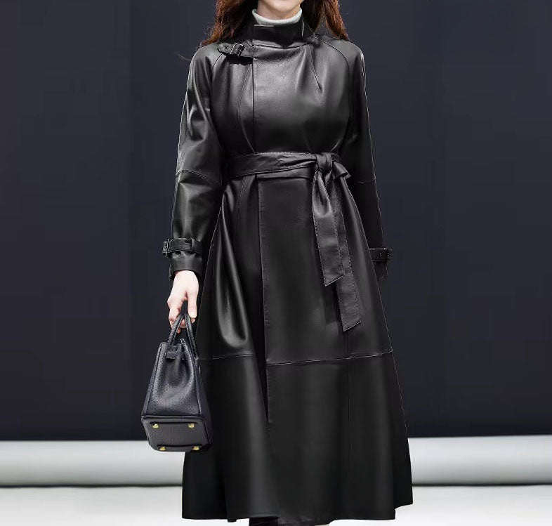 Women's Avant-Garde Wrap Coat in Onyx. Model carries a handbag, accentuating the coat’s commanding structure and refined leather craftsmanship. Borcelleclothes.