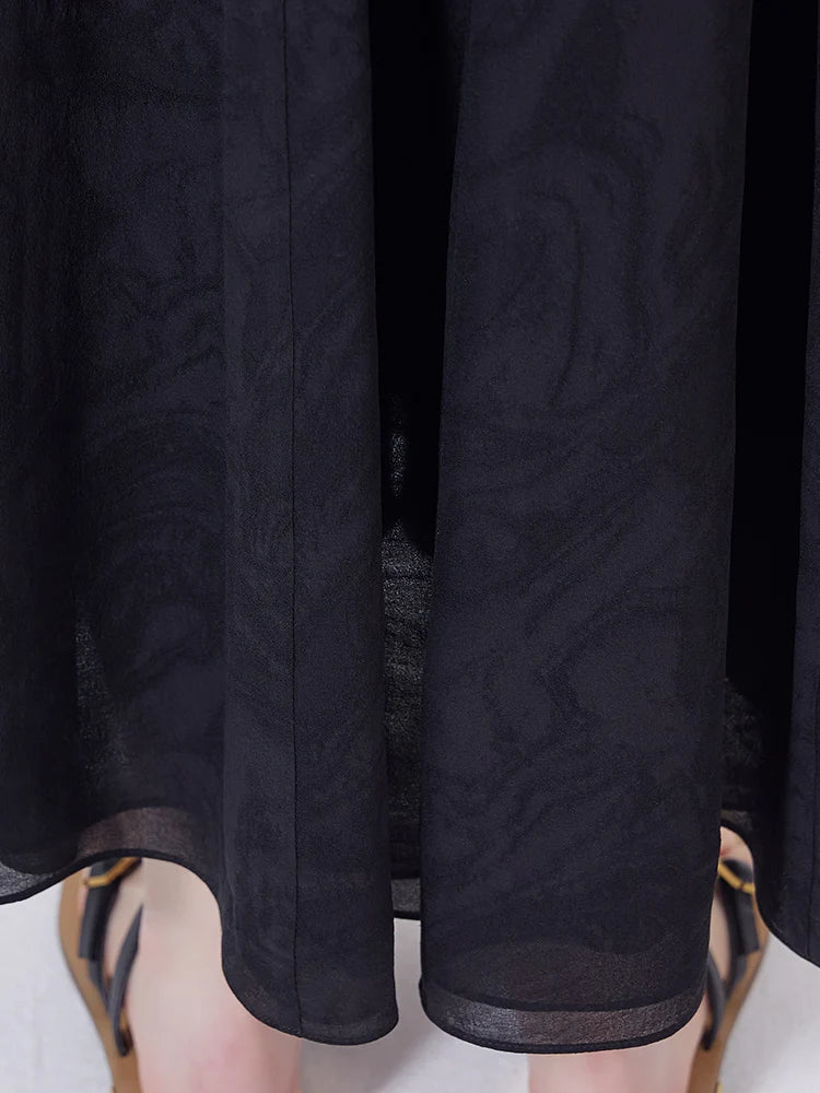 Close view of the ankle-length hem in textured Baltic Sea silk jacquard. From Borcelleclothes.