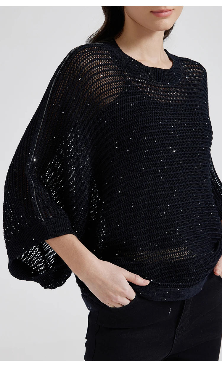 Close shot of Onyx mesh top with model’s hand resting in pants pocket, highlighting batwing drape and ribbed hem. From Borcelleclothes.