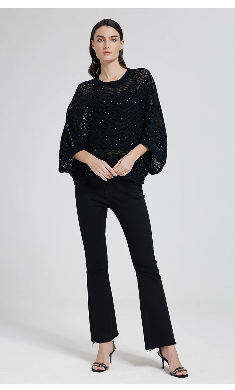 Woman in Onyx mesh top gently touching her hands, dark linen mesh creating a quiet contrast with skin. From Borcelleclothes.