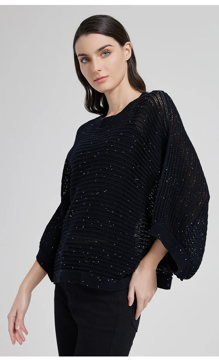 Woman in Onyx batwing linen mesh top, turned slightly to the side, light reflecting softly across openwork loops. From Borcelleclothes.