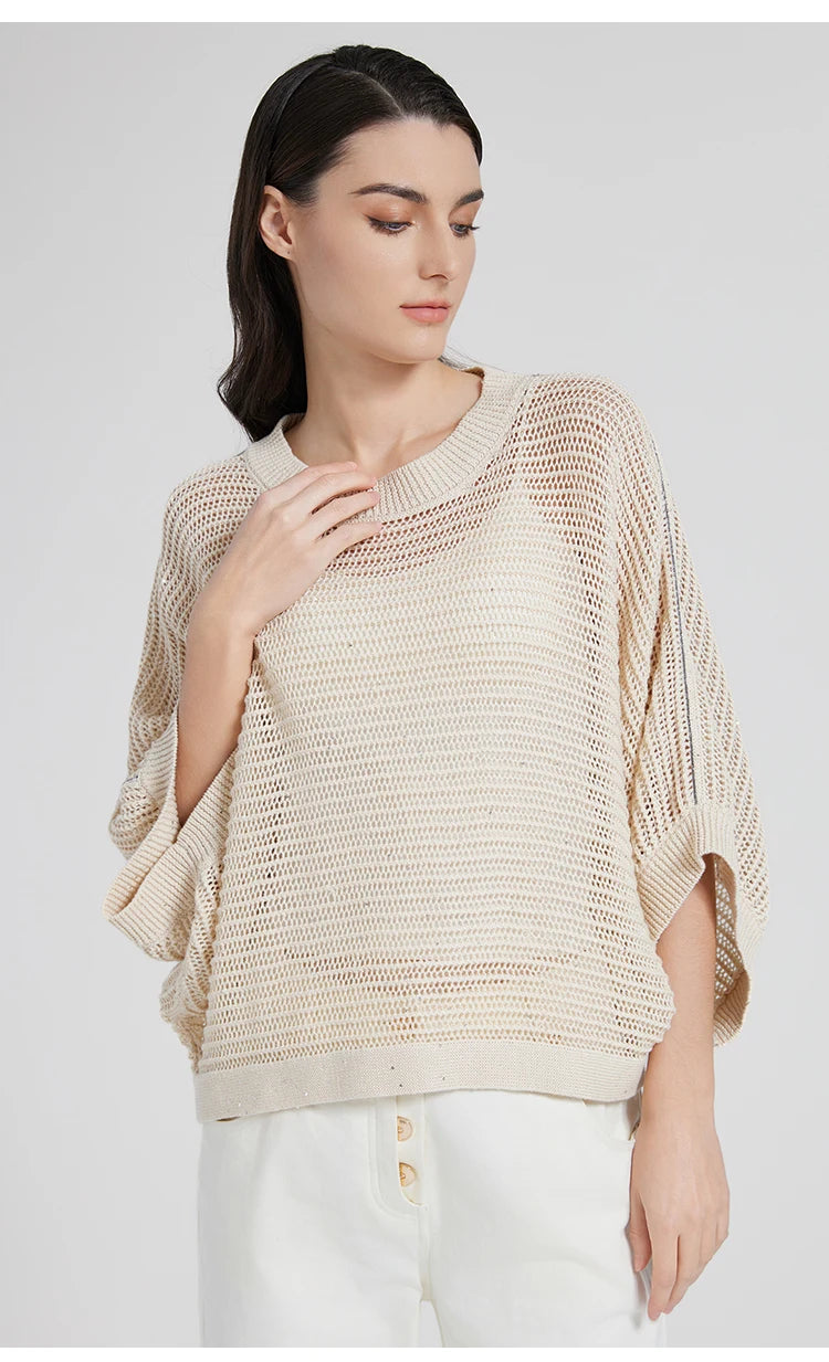 Close view of woman gently touching the wide ribbed neckline of the Spring Wood linen mesh top. From Borcelleclothes.