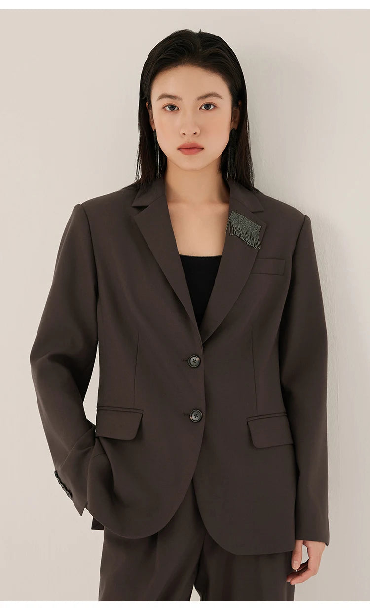 Woman in black chocolate blazer with rhinestone fringe detail, looking straight ahead – from Borcelleclothes.