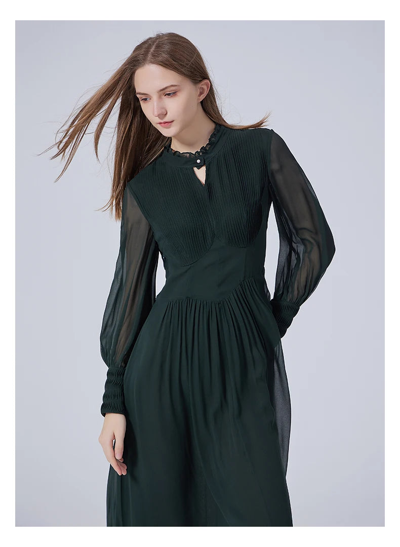 Model slightly bent to the side in the Lunar Green silk dress, showing the soft structure of the pintucked bodice. From Borcelleclothes.