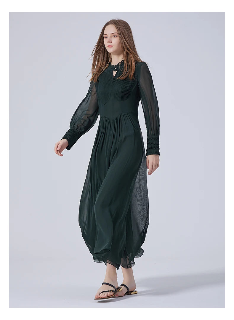 Model walking sideways in the Lunar Green silk dress, showing movement of the double-layered chiffon skirt. From Borcelleclothes.