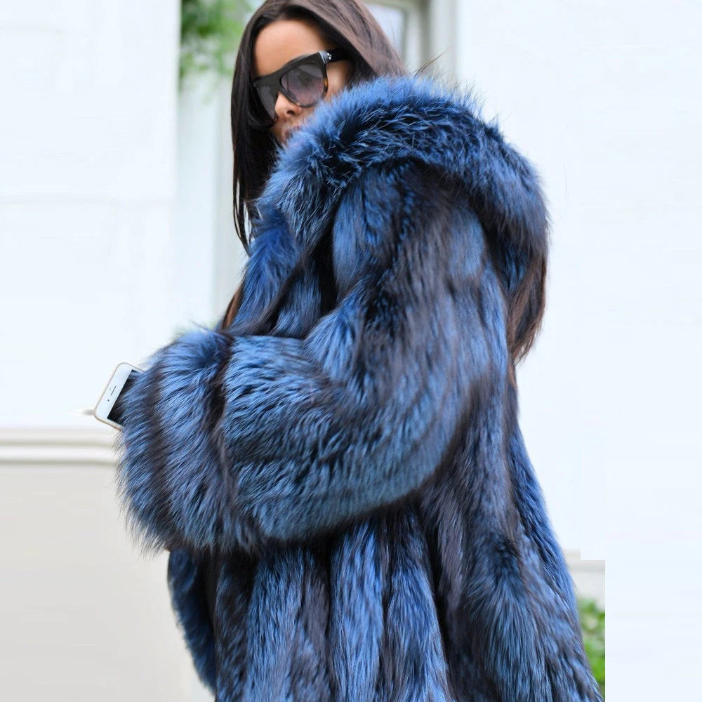 A woman in a Calypso silver fox fur coat captured from the side, the deep blue fur flowing effortlessly with her movement, embodying fluid elegance and quiet magnetism. From Borcelleclothes.