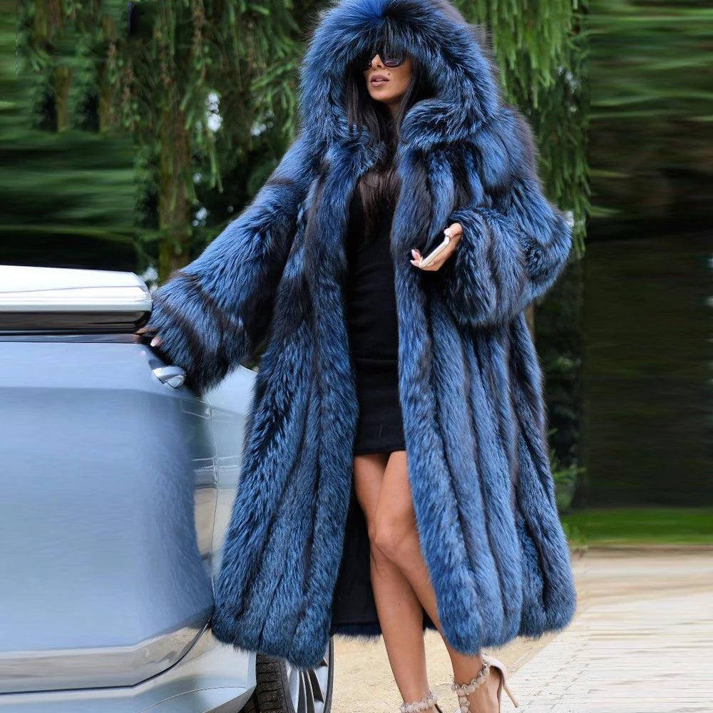 A woman in a Calypso silver fox fur coat gently touches a car, the rich blue fur catching the light, reflecting both movement and depth. From Borcelleclothes.