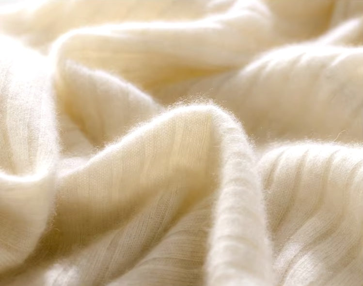 Demo of a Women's Cashmere Midi Dress in Merino being held, showing its elegant draping and soft cashmere texture. From Borcelleclothes.