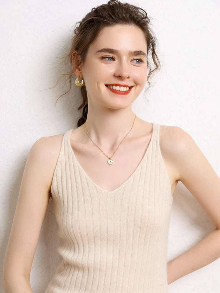 Model smiling in a Women's Cashmere Midi Dress in Merino, featuring front and back V-necklines and a ribbed texture for a slimming silhouette. From Borcelleclothes.