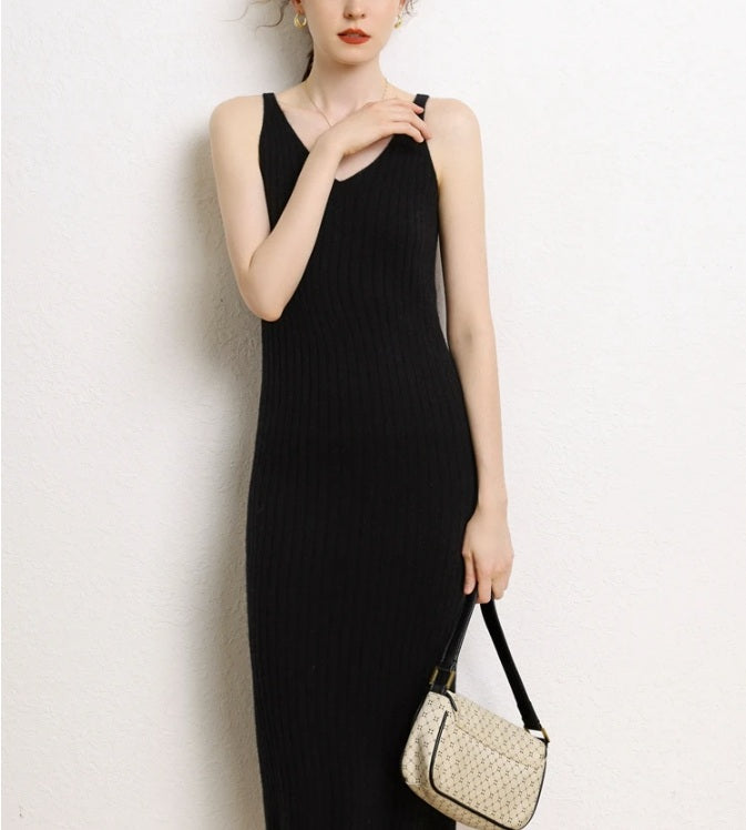 Model wearing a Women's Cashmere Midi Dress in Onyx, touching left strap. From Borcelleclothes.