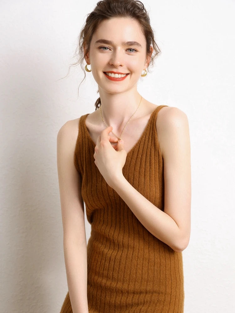 Model smiling in a Women's Cashmere Midi Dress in Sienna, featuring front and back V-necklines and a ribbed texture for a slimming silhouette. From Borcelleclothes.