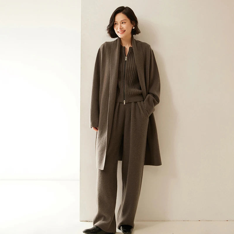 Model wearing Umber pleated cashmere trousers and matching coat — From Borcelleclothes.