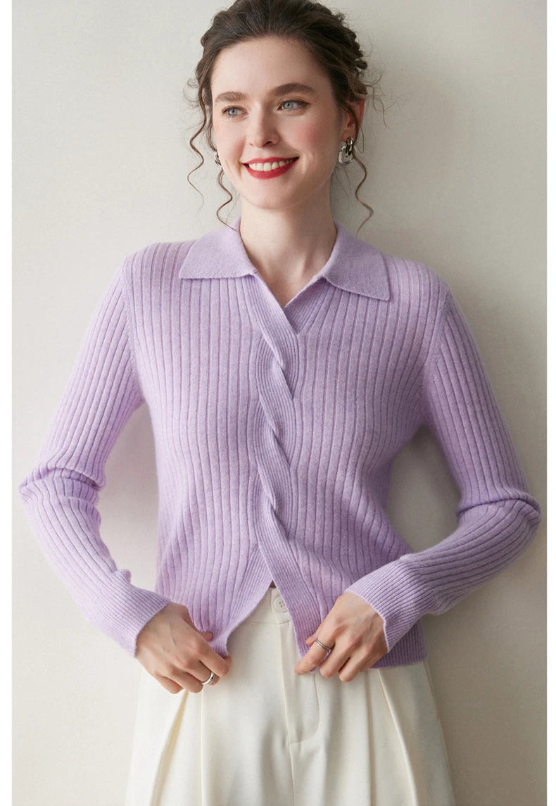 Model adjusting bottom hem of women’s cashmere rib sweater in Wisteria Purple — From Borcelleclothes.