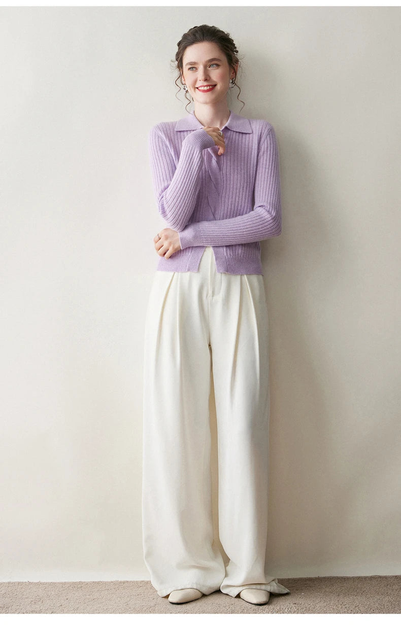 Model touching collar of women’s cashmere rib sweater in Wisteria Purple — From Borcelleclothes.