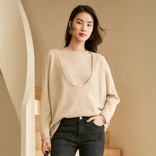 Model in Foggy Grey cashmere set with deep neckline, hand resting in pants pocket — From Borcelleclothes.