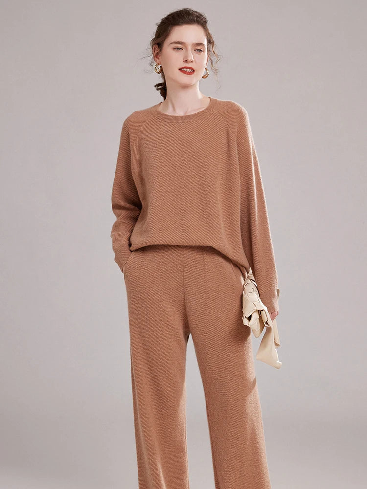 Model in Café Au Lait diagonal-knit cashmere set, holding a tonal handbag – From Borcelleclothes.