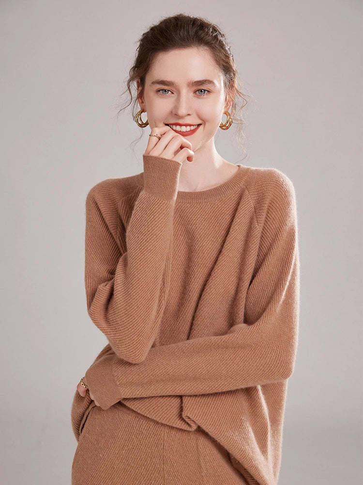 Model in Café Au Lait cashmere set, gently touching her chin – From Borcelleclothes.