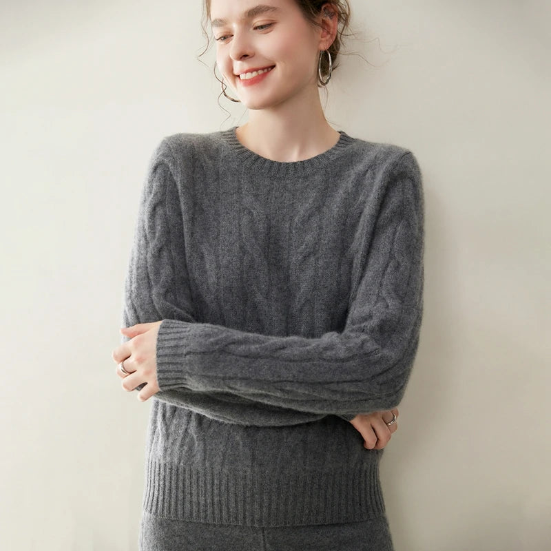 Women's cashmere set with two-strand cables in Davy Grey, model with arms crossed — From Borcelleclothes.