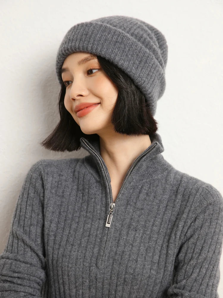 Smiling model looking sideways in cashmere sweater in shifting ribs, Davy Grey — From Borcelleclothes.