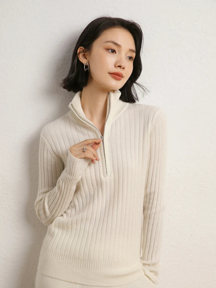Model touching zipper puller in cashmere sweater in shifting ribs, Pearl Bush — From Borcelleclothes.