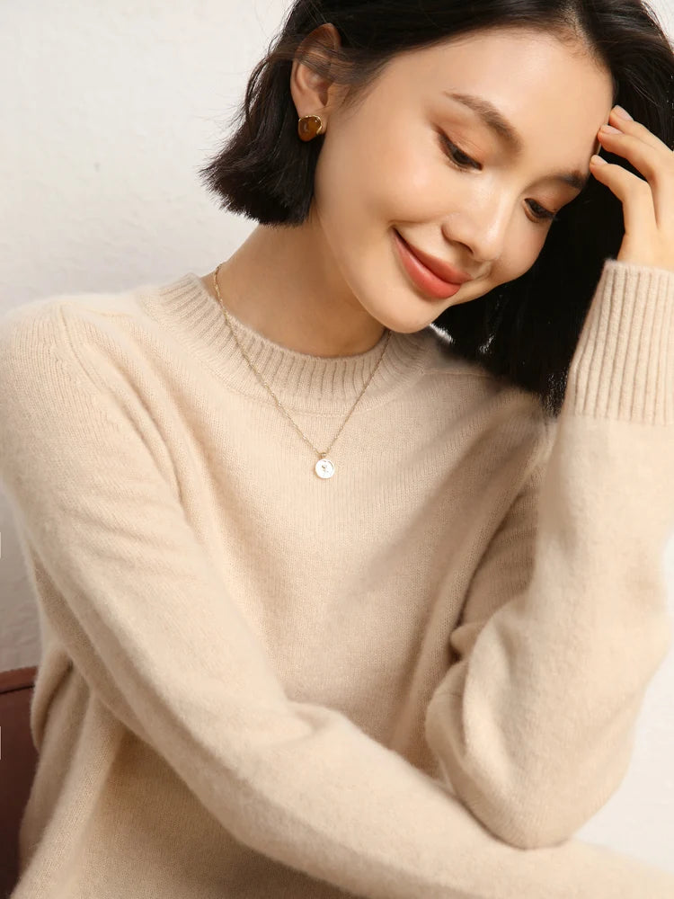 Woman in Almond cashmere sweater with hand resting on forehead – From Borcelleclothes.