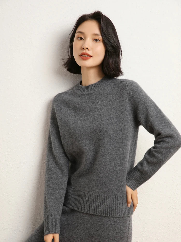 Woman in Dove Grey cashmere sweater with hand on hip – From Borcelleclothes.