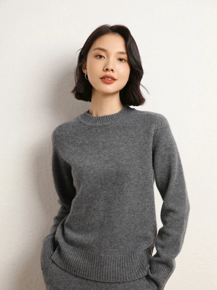 Woman in Dove Grey cashmere sweater with hands in matching pants pockets – From Borcelleclothes.