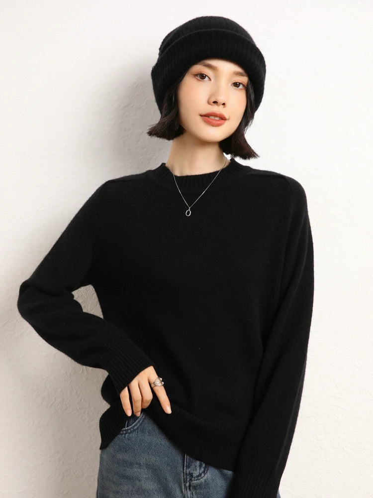 Woman in Onyx cashmere sweater lifting bottom hem slightly – From Borcelleclothes.