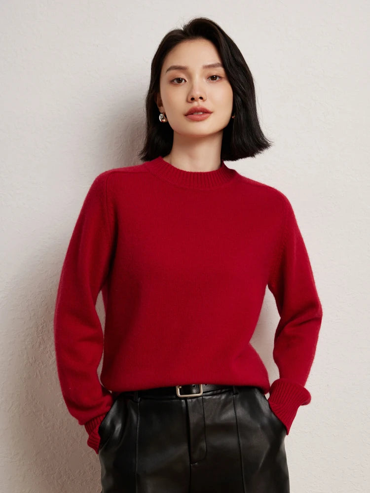 Woman in Red Devil cashmere sweater with hands in black leather pants pockets – From Borcelleclothes.