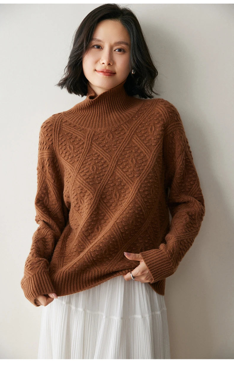 Model in Dark Russet cashmere sweater touching the hem, highlighting soft drape and raised oval pattern — From Borcelleclothes.