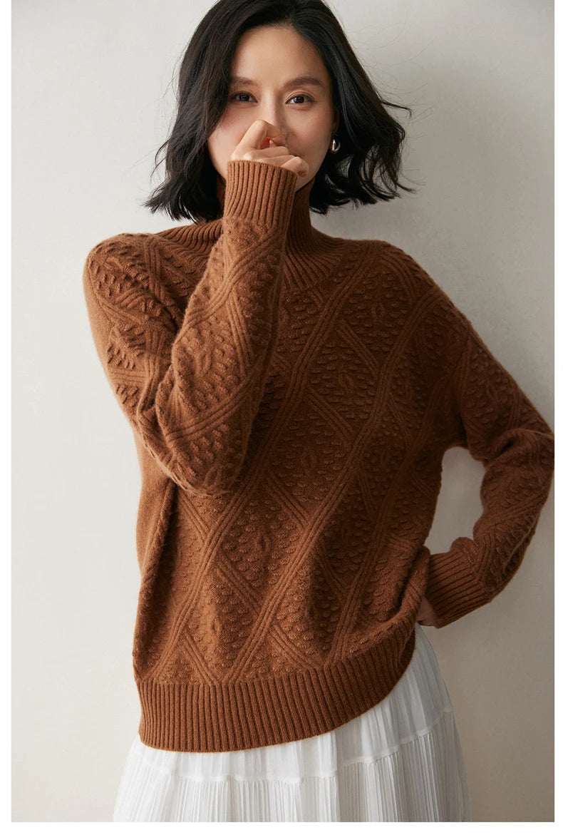 Dark Russet cashmere sweater with diamond motif, model touching nose with one hand and resting the other on hip — From Borcelleclothes.