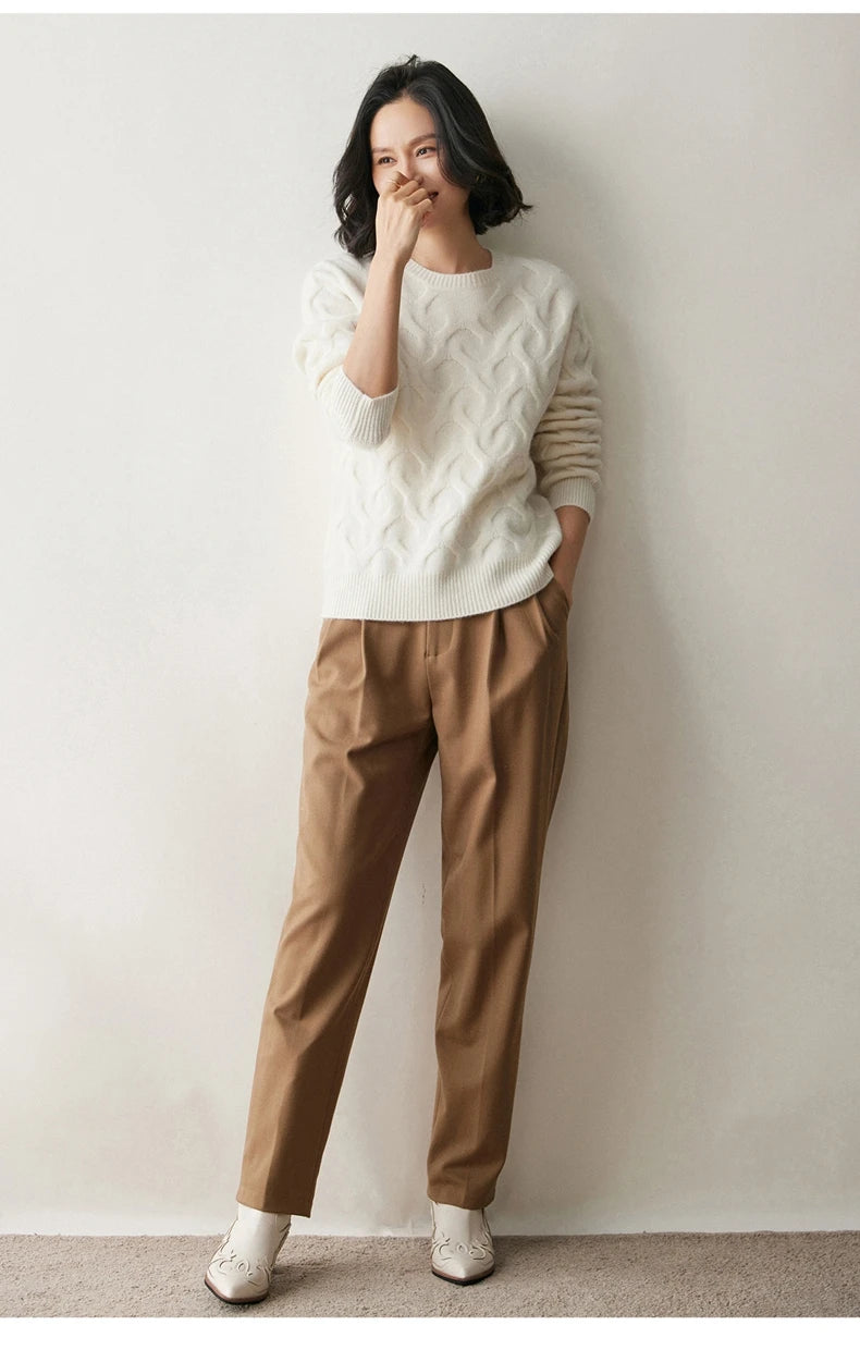 Model in Pearl Bush cashmere sweater gently touching her nose, showcasing the relaxed silhouette — From Borcelleclothes.