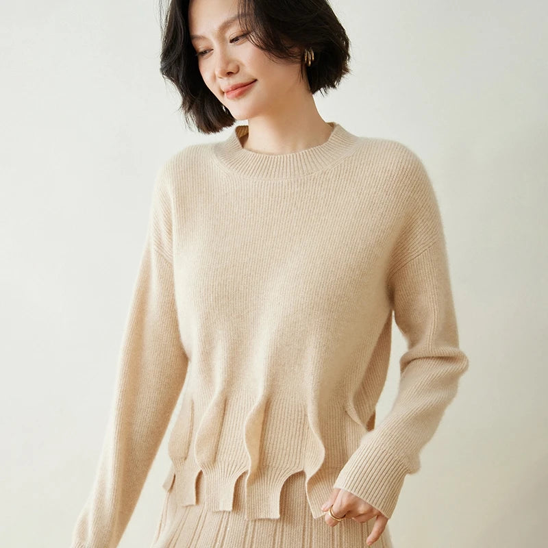 Women’s cashmere sweater in Vanilla, with staggered seam construction and sculptural flounces — From Borcelleclothes.