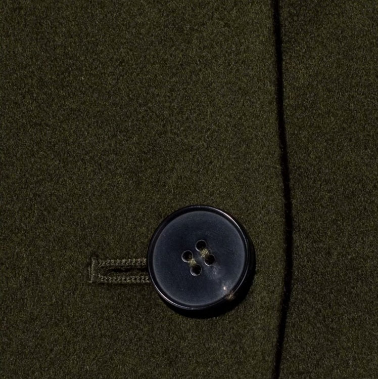 The horn button on the women's cashmere trench coat, highlighting its refined craftsmanship and attention to detail. From Borcelleclothes.