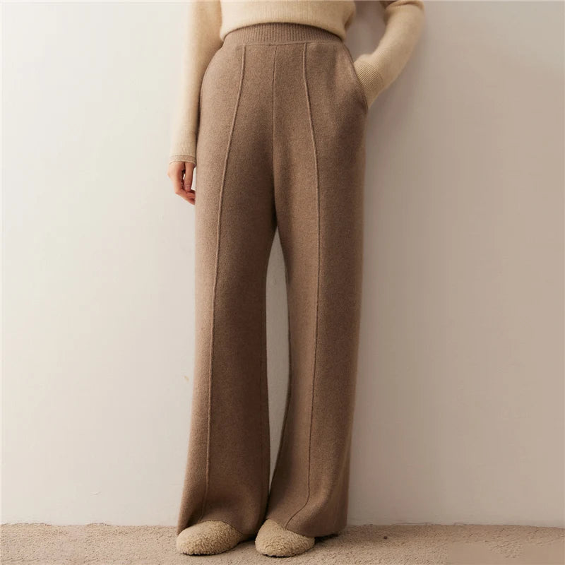 Model wearing pastel brown cashmere trousers with tuck detail, hand in pocket — From Borcelleclothes.